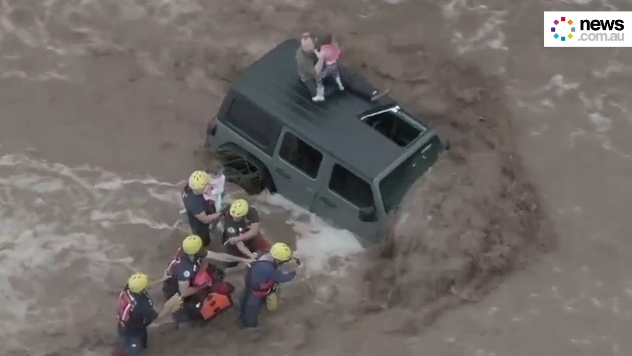 Man and two daughters rescued from car roof amid flash flooding in ...