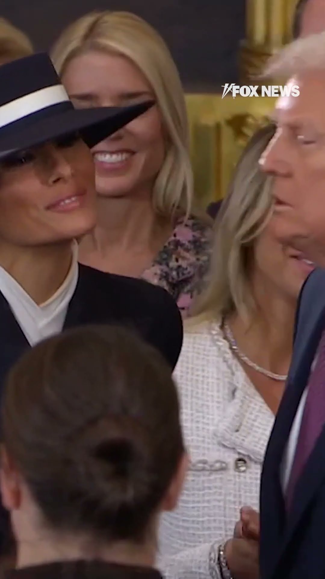 Trump's cheek kiss is blocked by Melania's hat