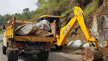 Jcb 3dx super loading boulder into a truck