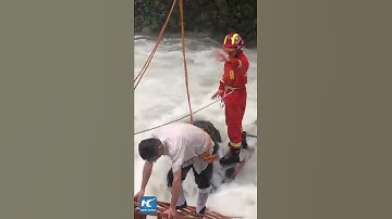 Driver trapped in flash flood, rescued by firefighters with two ladders