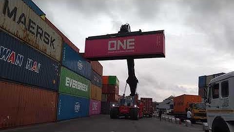 Kalmar Reach stacker with a tilting spreader for container handling.