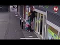 Woman left dangling in mid air after being lifted off her feet by shop shutters