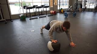 Alternating plyo push ups with medicine ball