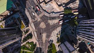 Aerial birds eye overhead top down descending hyperlapse footage of traffic on road intersection