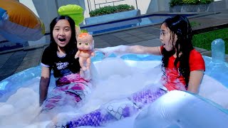 Aina and Alia Play With Doll Inside a Pool Of Bubbles