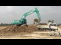 Kobelco excavator digging land on truck in Cambodia (2)