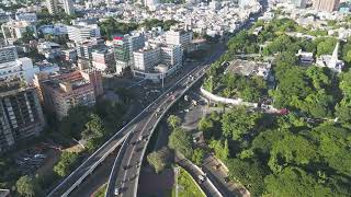 Elevated highway flyover intersection with dense urban buildings and green parks | CHENNAI 4K Dro...