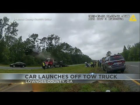 Car launches off tow truck