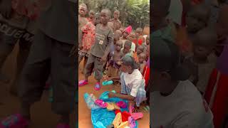 People are giving sandals to children at an orphanage to prevent problems with their feet!