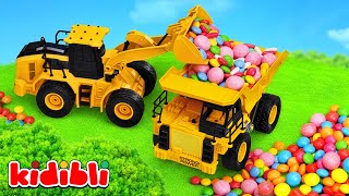 Construction Vehicles Save the Candy Farm 🍭 Excavator & Tractor | Toy Video for Kids | Kidibli
