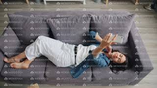 Top view of beautiful woman taking selfie with smartphone camera lying on couch screenshot 4