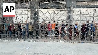 Desperate Palestinians line up for bread in Gaza City amid famine warning