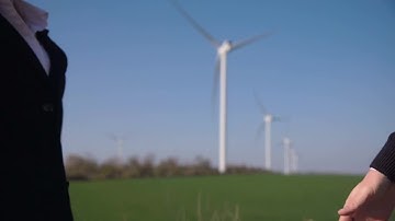 Business Handshake With Wind Turbines Stock Video