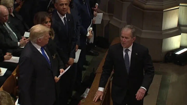George W Bush sneaks candy to Michelle Obama at Bu...