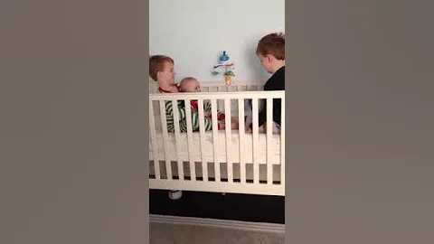 Three boys in crib