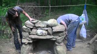 Preparing for the cold of winter with an outdoor stone fireplace. Built all natural. No store bought materials.
