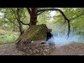 Building complete and warm rock survival shelter with a knife bushcraft survival skills fireplace