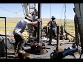 Roughnecks at work in  drilling rig pipe connection