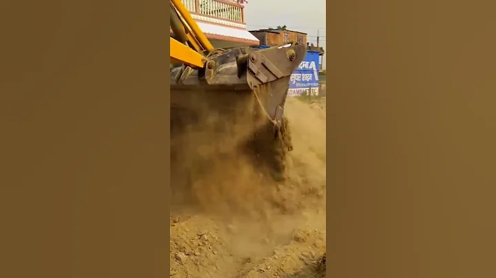 jcb backloader cutting gravel on the road.