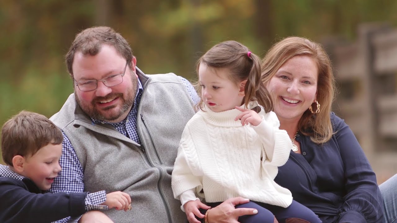 A family photographed together outdoors during an earlier fall session.