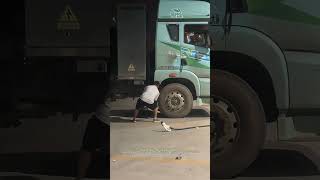 Why You Should Charge Timely : Electric Truck Driver Prying Wheels For A Short Charging Cable