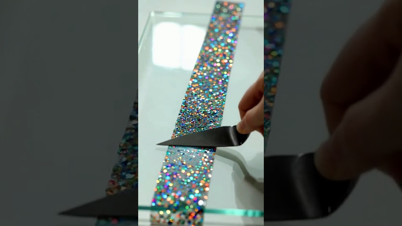 AI ASMR : iridescent glitter glue being peeled off glass