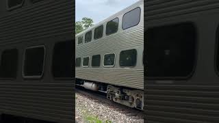 An Outbound Express Pulled by METX 188 Speeds Past Riverside Alongside a Freight Train
