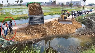 Nicely project landfill by Bulldozer D31p working push stone and Dump truck 5T unloading soil fill