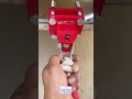 A heavy duty red steel recovery hitch being assembled and mounted to a vehicle frame