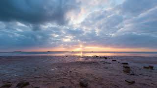Sundown Spectacle: Dramatic Clouds and Sunset Rays Over Crystal Beach Timelapse