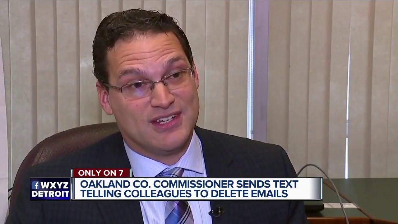 channel awesome Oakland Co. Cover-up? Text that reads DELETE, DELETE, DELETE over L. Brooks Patterson's seat