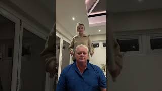 Dad and daughter using wrapping paper tubes to play music on dad's head!