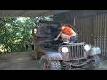 The girl is repairing various parts including the engine of an old jeep car