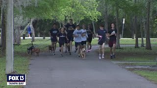 High school crosscountry team takes shelter dogs out for a run