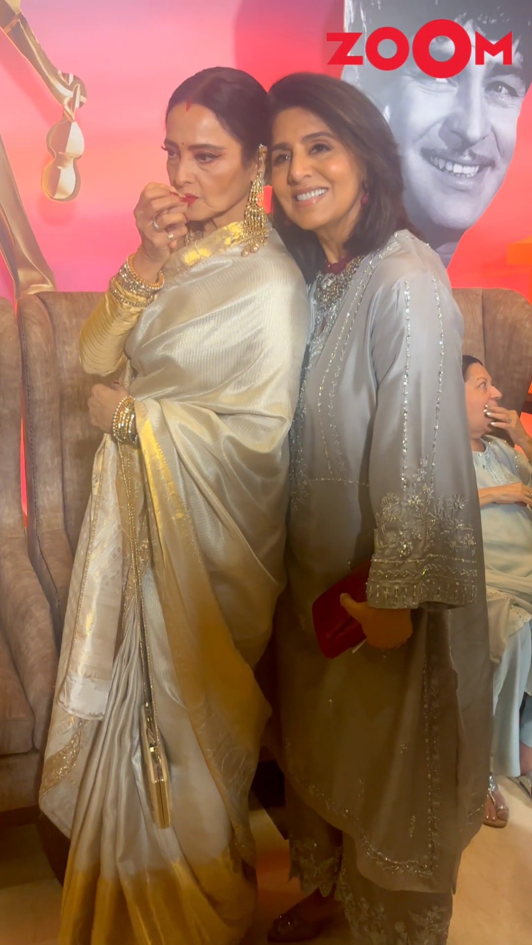 Rekha KISSES Neetu Kapoor's hand while posing for paps at 100 years of Raj Kapoor celebration ?