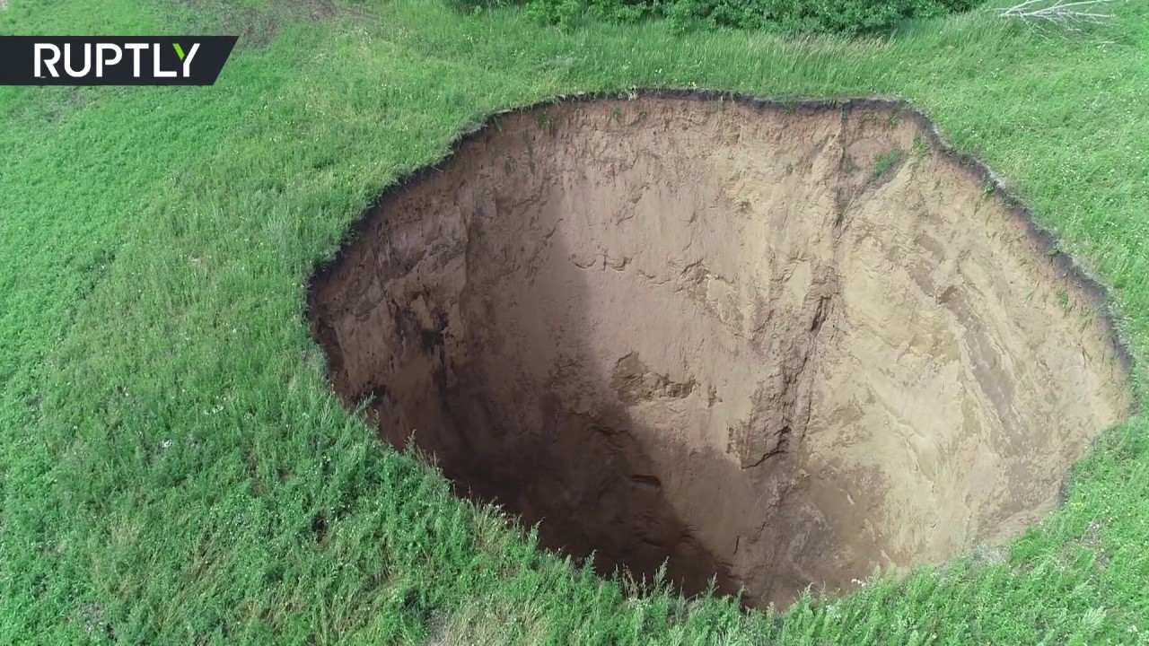 Massive Sinkhole Appears In The Middle Of A Field In Russian Countryside