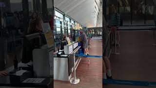 Guy is struggling to make his bag fit at the airport!