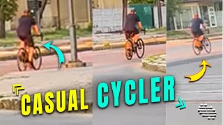 Cycler Going About His Day as Tank Passes By