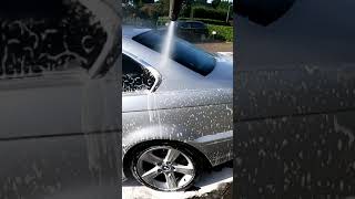 Hose Down Dirty Car With High Pressure Washer In Slow Motion