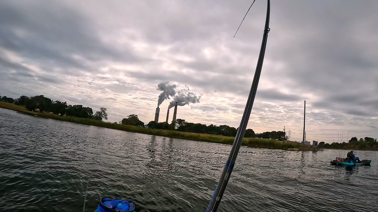 Two Kayakers Trying to Bass Fish on a Big Lake