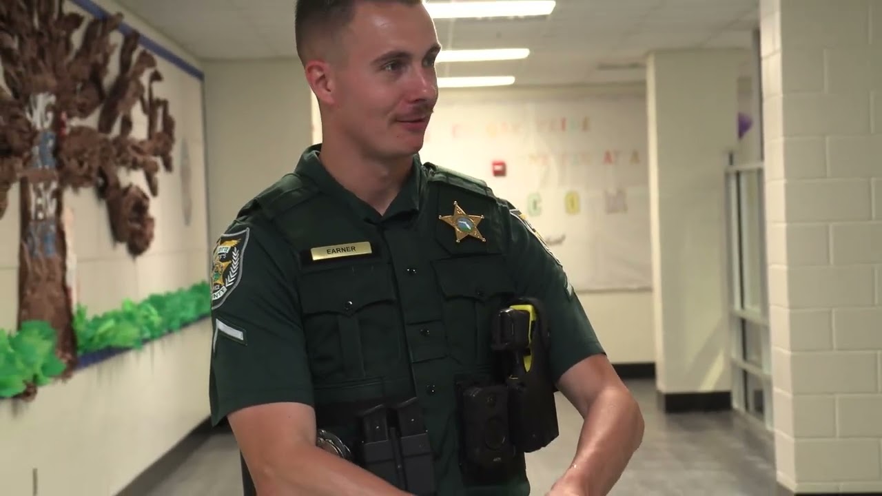 Video preview image of A deputy in a school building; click to visit the ParentSquare post with the video