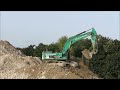 Excavator CAT 345 D and the building rubble heap