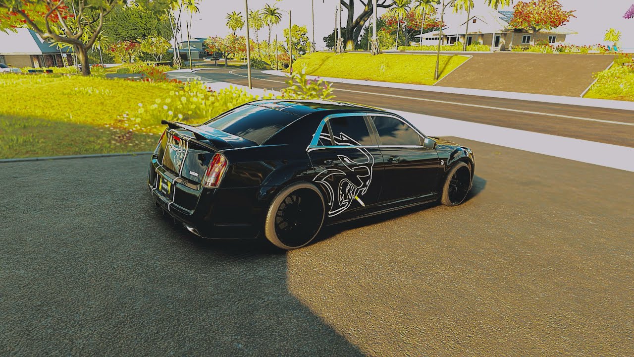 Chrysler 300 SRT8 parked on a racetrack, showcasing its aggressive stance and glossy finish