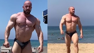 Huge Italian bodybuilder walking on the beach