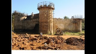 A group of French individuals are building a 13th century Castle with period-appropriate tools and m