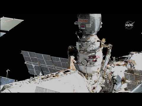ISS crew members work on new robotic arm