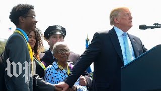 Trump clutches grieving family of fallen officer