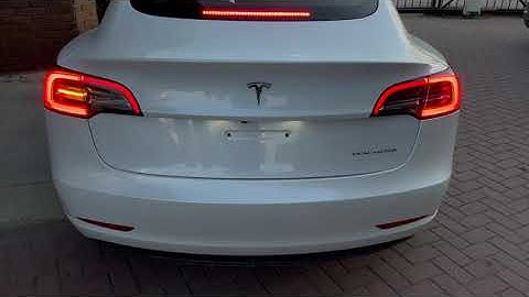 Tesla Model 3 "New" amber tail lights with Teslogic adapter at right