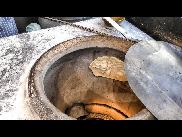 Naan Indian Bread Hand Made and Cooked in a Clay Oven in Old Spiltafields  Market, London 