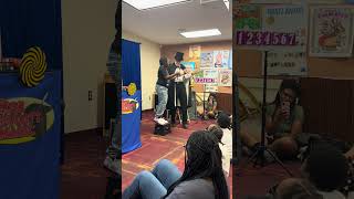 My nephew helping the magician do a magic trick at the library today 
